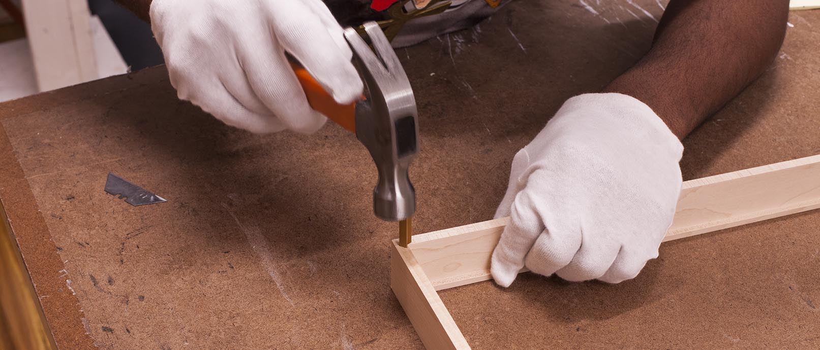 hammer connecting sides of wood picture frame