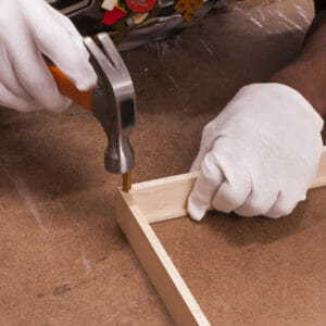 hammer connecting sides of wood picture frame