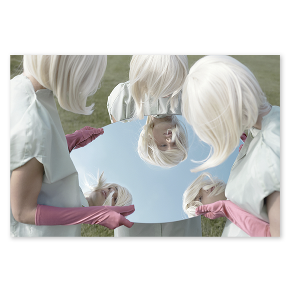 three white haired women looking into a mirror