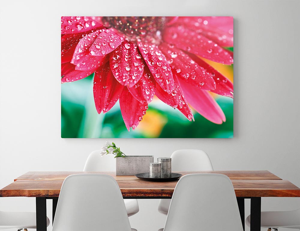 Display of the perfect poster canvas size with this vibrant pink flower over a dining room table.