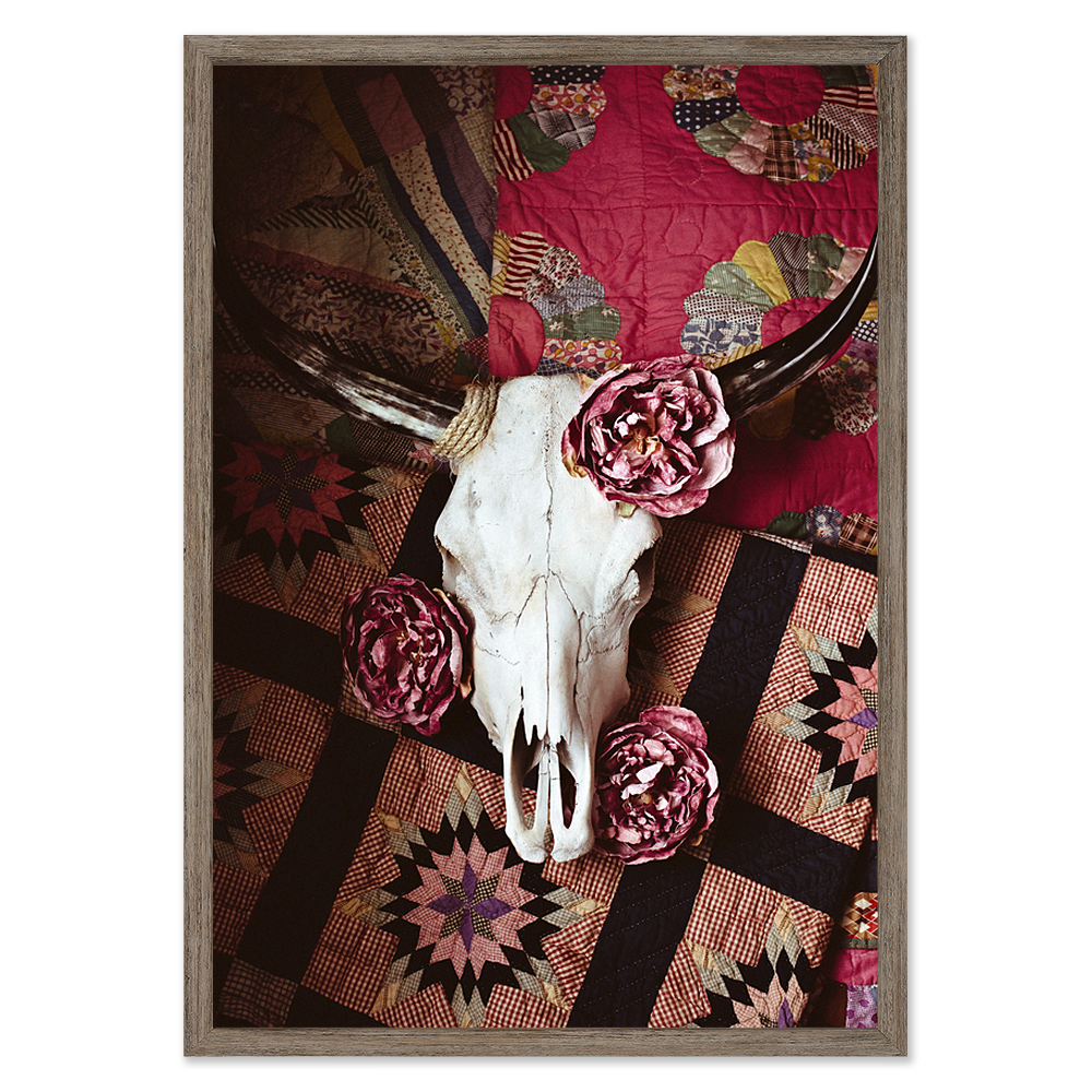 goat skeleton on a quilt surrounded by flowers